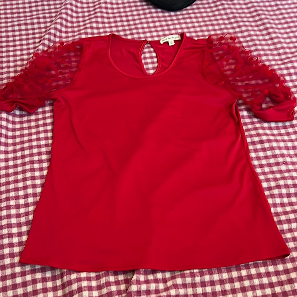 Selling a red shirt by above and beyond the size is a large